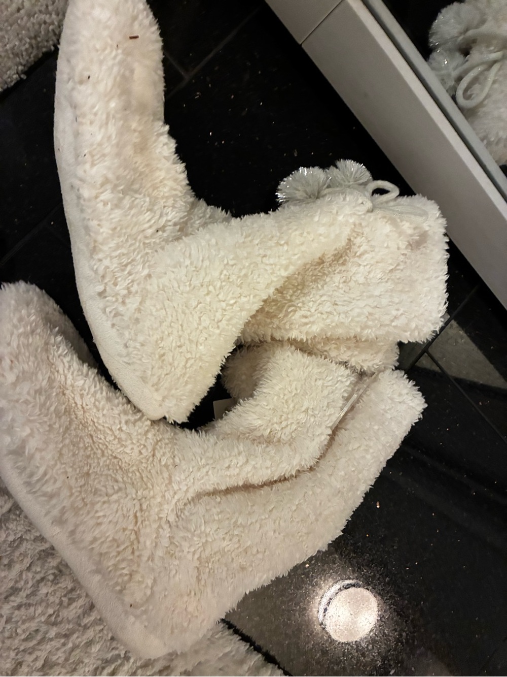 House shoes. White fuzzy boots. Size 9-10. Can fit a size 8. Very soft. Nwt